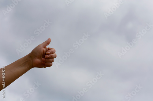 Thumb up on the background of the sky. Success concept