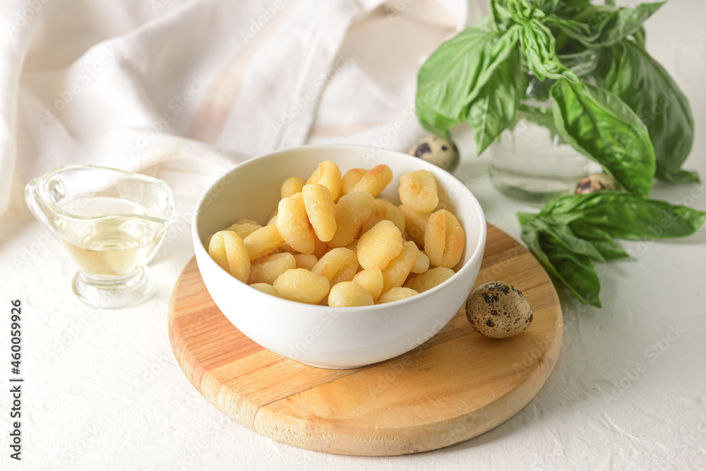 Bowl with tasty gnocchi on light background Bowl with tasty gnocchi on light background