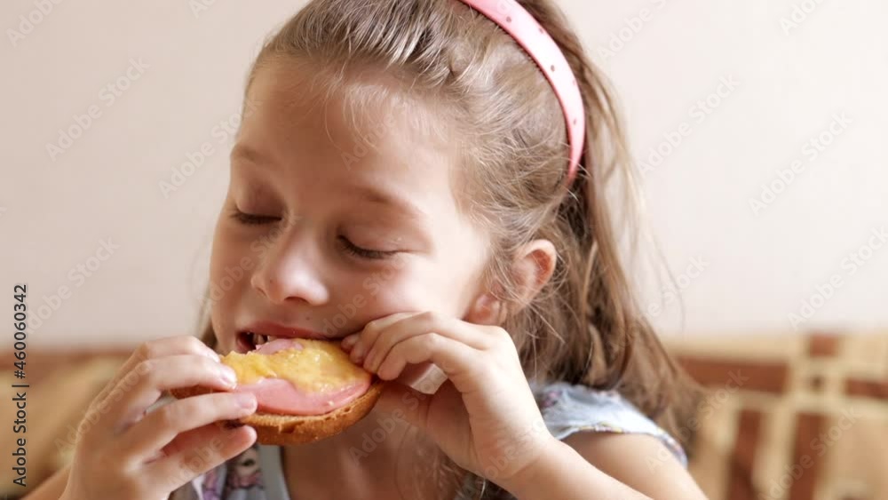little girl has breakfast sandwiches in the morning for breakfast before school little girl has breakfast sandwiches in the morning for breakfast before school