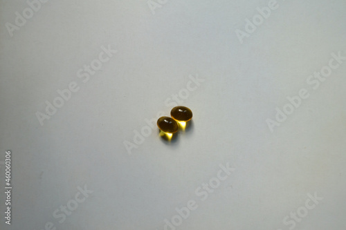 Pair of yellow softgel capsules of vitamin A (retinyl palmitate) © Anna