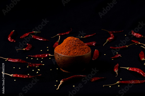Pile crushed red pepper, Cayenne pepper, dried chili flakes isolated on black background