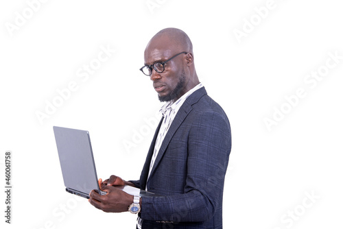 close-up of a young businessman holding laptop, pensive.