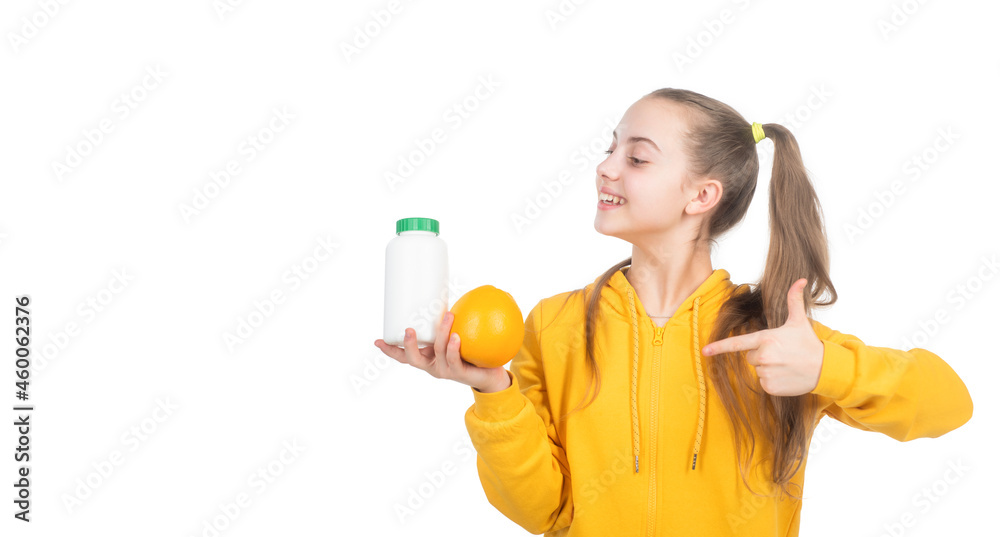 happy teen girl pointing finger on orange fruit and vitamin pill, natural supplement. happy teen girl pointing finger on orange fruit and vitamin pill, natural supplement.