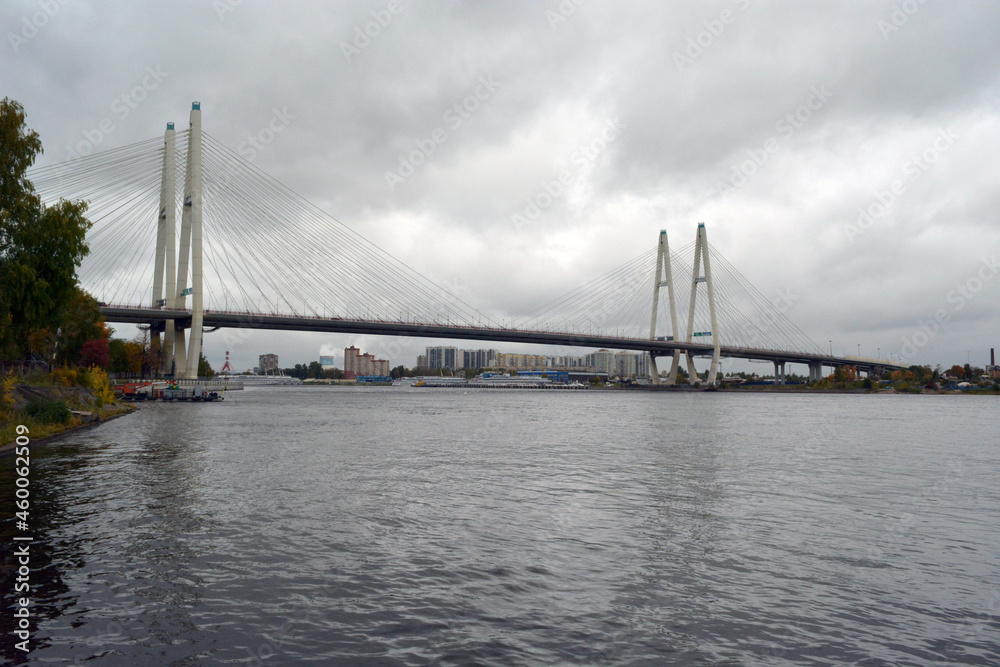 The Bolshoy Obukhovsky Bridge (Saint Petersburg, Russia) across the Neva river on grey cloudy weather. The Bolshoy Obukhovsky Bridge (Saint Petersburg, Russia) across the Neva river on grey cloudy weather.