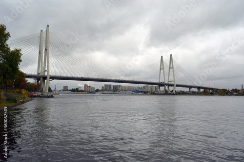 The Bolshoy Obukhovsky Bridge (Saint Petersburg, Russia) across the Neva river on grey cloudy weather.