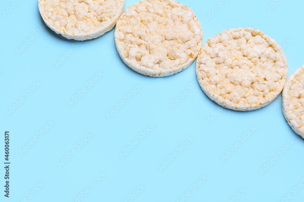 Puffed rice crackers on color background
