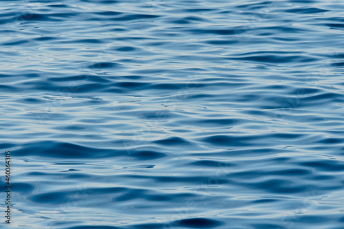Blue clear sea water. Quiet, calm sea, reflecting the evening sky. Texture