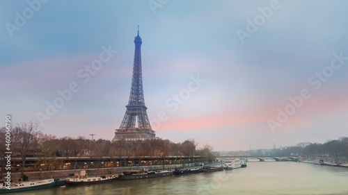 The Eiffel Tower, iconic Paris landmark across the River Seine with the tourist boat in sunset sky scene at Paris ,France background