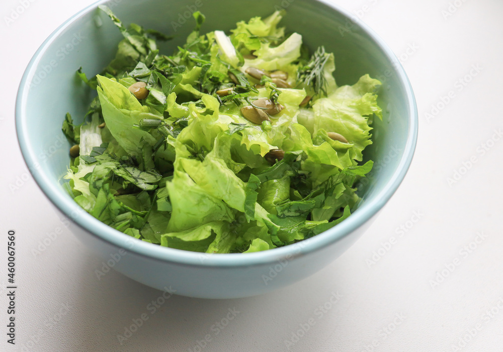 fresh salad leaves with pumpkin seeds in a plate, close-up. Comfortable digestion, proper nutrition, weight loss. The texture of vegetables, salad. Seasonal vitamins, fiber fresh salad leaves with pumpkin seeds in a plate, close-up. Comfortable digestion, proper nutrition, weight loss. The texture of vegetables, salad. Seasonal vitamins, fiber
