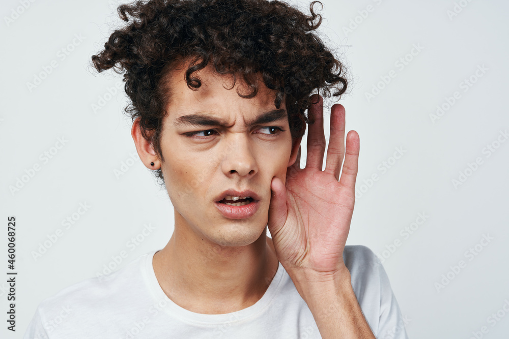 a guy in a white t-shirt has poor hearing health problems a guy in a white t-shirt has poor hearing health problems