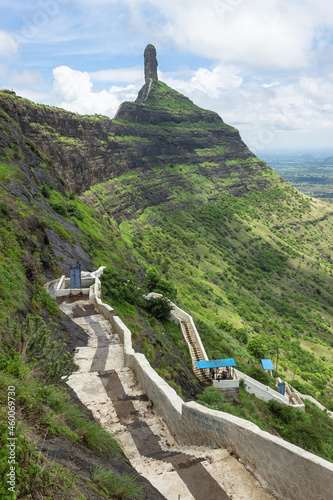 View of stairs and Tungi hill rock, Mangi Tungi, Nashik, Maharashtra, India. Prominent twin-pinnacled peak with plateau in between. photo