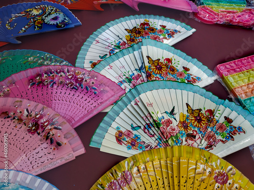 colorful fan with figures of roses, butterflies and hummingbirds