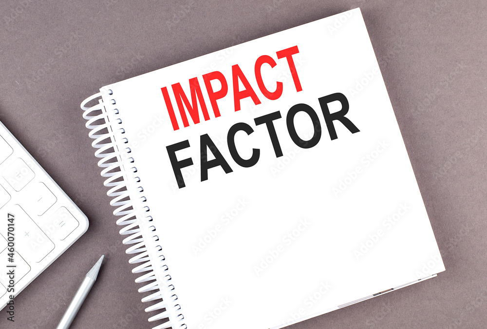 IMPACT FACTOR text on notebook with calculator and pen,business concept IMPACT FACTOR text on notebook with calculator and pen,business concept
