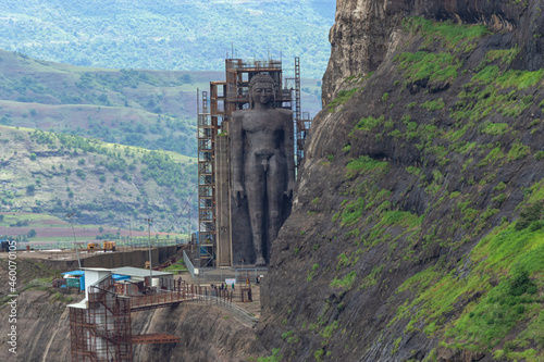 View from Tungi hill of 108 ft Jain Idol of Rishabhdev Bhagwan believed to be the first Tirthankara in Jainism. Mangi Tungi hills. Nashik, Maharashtra, India. photo