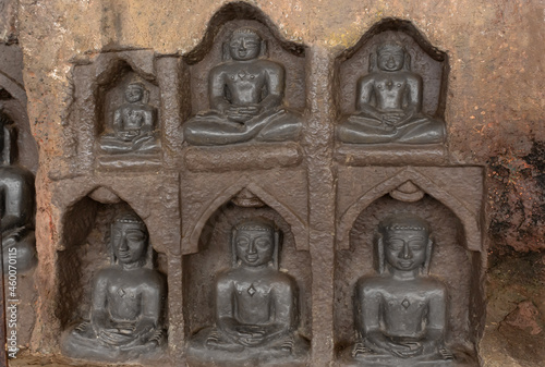 Carved idols of Digambar Jain Tirthankaras on the rock of Mangi Tungi, Nashik, Maharashtra, India. photo