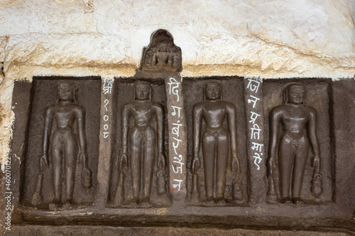 Carved idols of Digambar Jain Tirthankaras on the rock of Mangi Tungi, Nashik, Maharashtra, India. photo