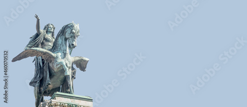 Canvas Print Banner with statue of Greek goddess Muse riding winged horse Pegasus in historical, touristic downtown in Vienna Austria at blue sky background and copy space