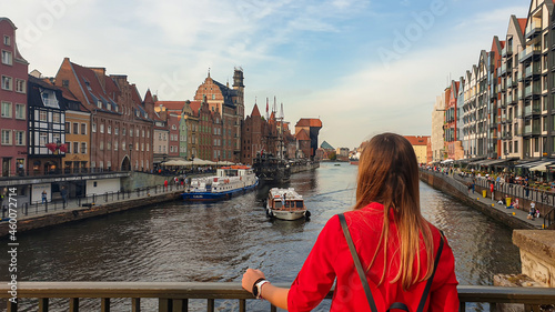 Cuadro en lienzo A woman enjoying the view on the shores of Martwa Wisla flowing through Gdansk in Poland, with medieval port crane