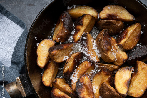 Fried potatoes in a skillet, junk food, fast food