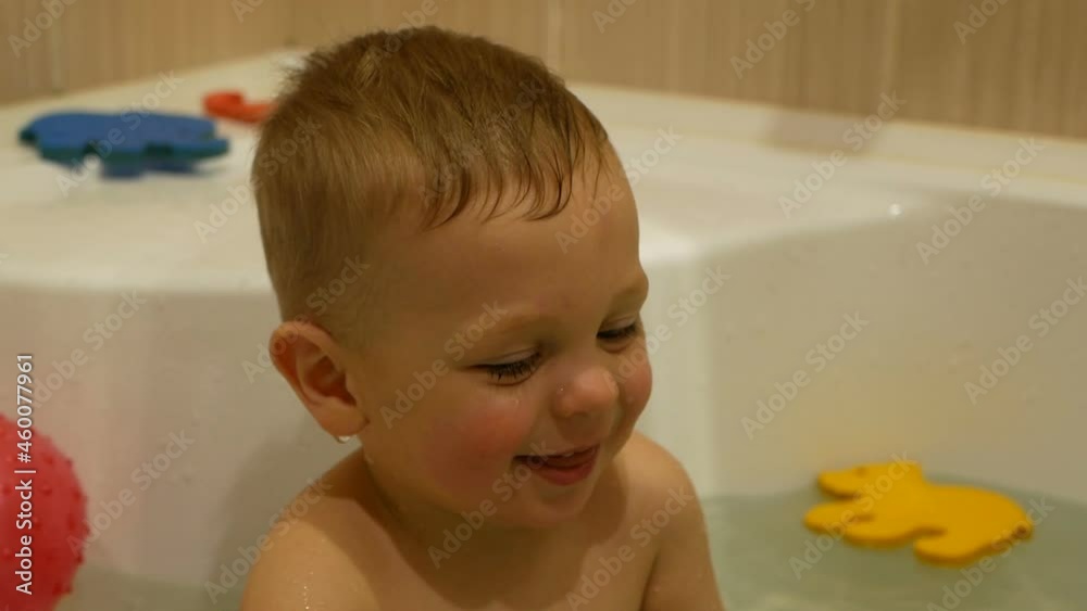 Child in the bathroom. Smiling kid in the bathroom with toys. Child in the bathroom. Smiling kid in the bathroom with toys.