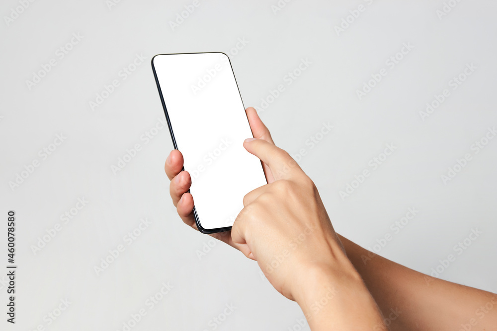 Woman hand holding phone on white background with copy space