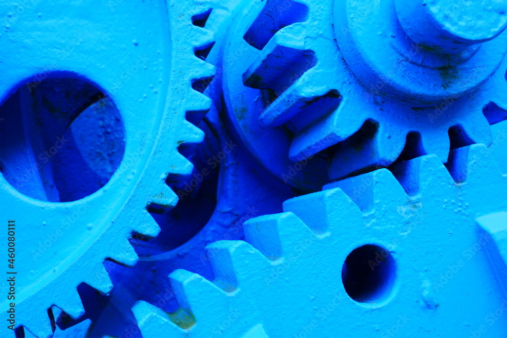 close up of three blue painted metal gears of a dam close up of three blue painted metal gears of a dam