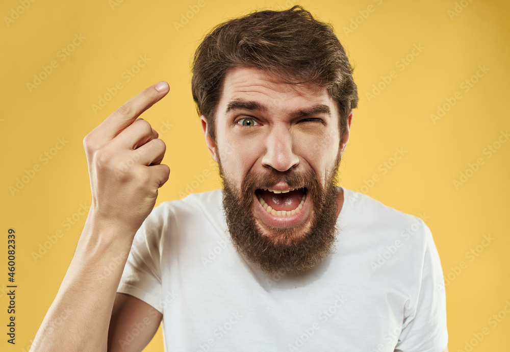 bearded man in a white t-shirt hand gestures anger Studio