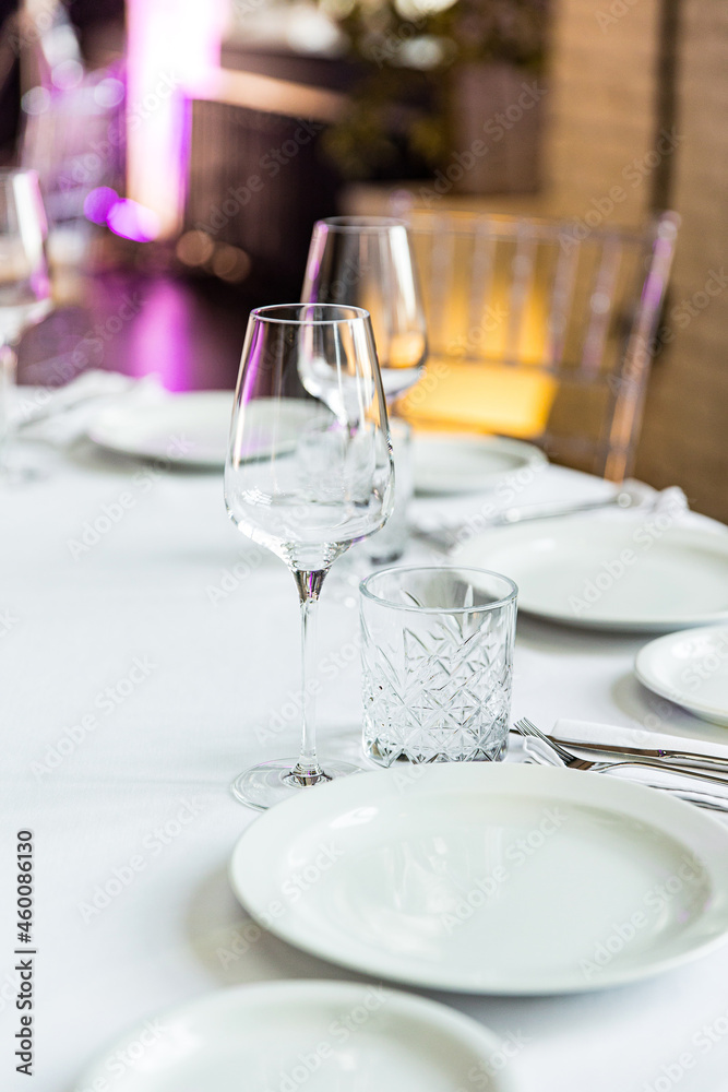 stylish empty glasses and plates at setting at elegant table for wedding reception, catering in restaurant stylish empty glasses and plates at setting at elegant table for wedding reception, catering in restaurant