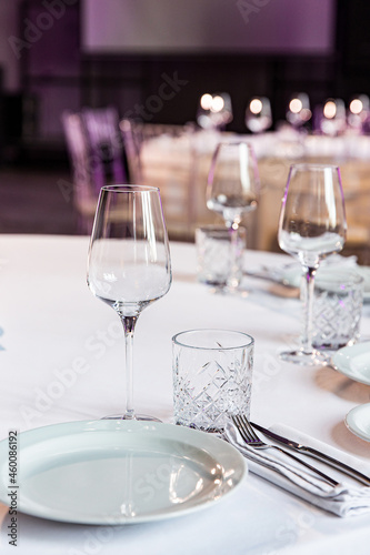stylish empty glasses and plates at setting at elegant table for wedding reception  catering in restaurant