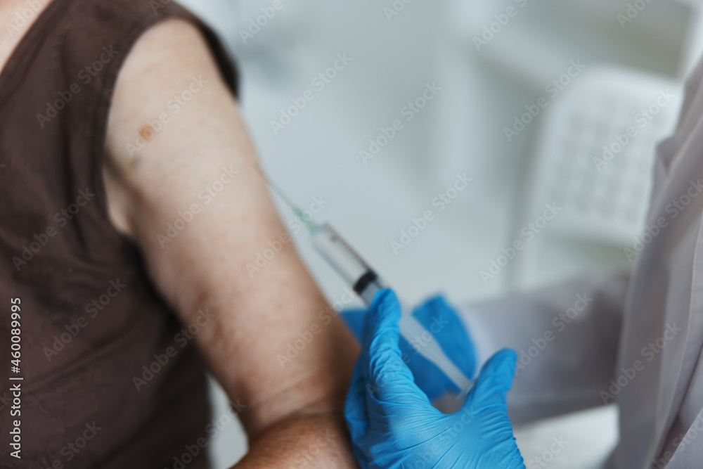 doctor makes an injection in the arm immunity protection covid passport close-up doctor makes an injection in the arm immunity protection covid passport close-up