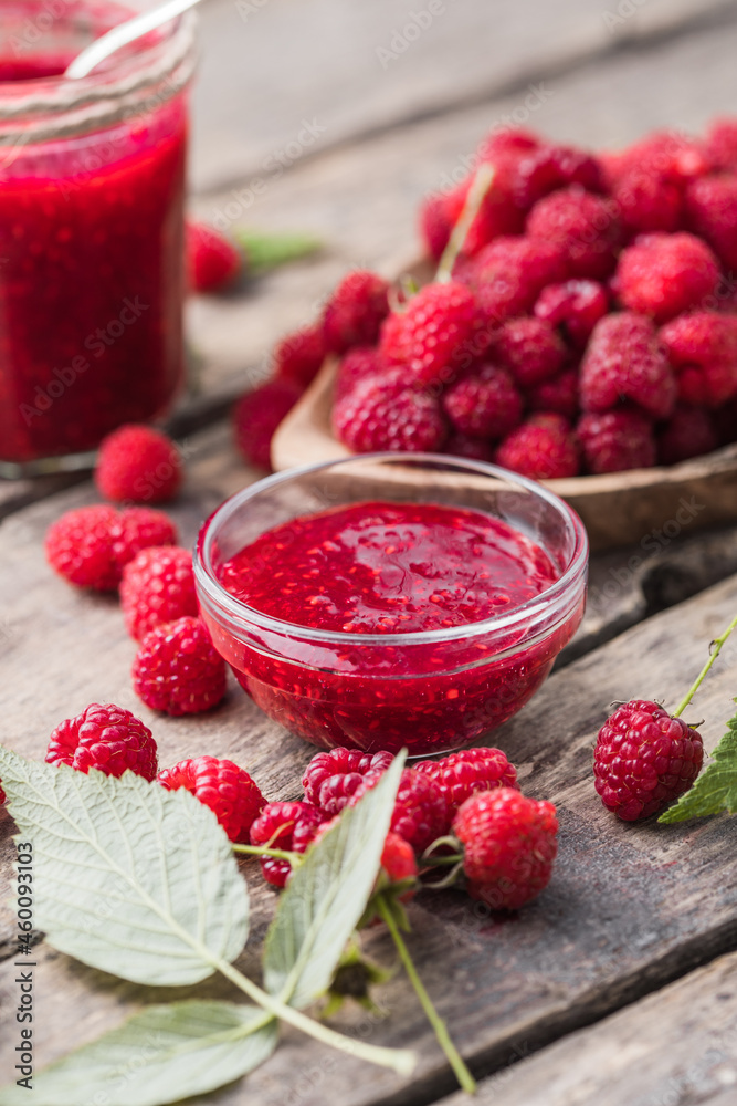 Jar of raspberry jam and fresh berries with leaves. Sweet dessert Jar of raspberry jam and fresh berries with leaves. Sweet dessert