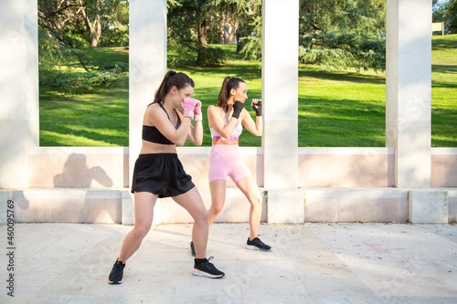 young caucasian women doing boxing exercises outdoor