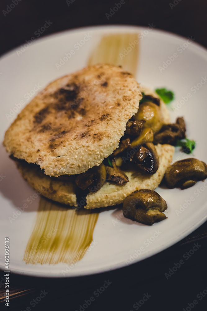 burger with mushrooms and chicken on a plate, food