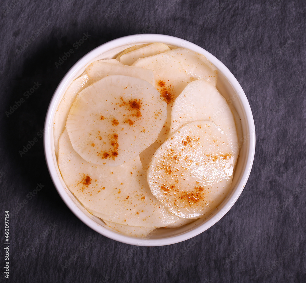 white radish slices with red pepper and oil white radish slices with red pepper and oil