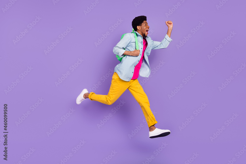 Profile photo of astonished guy jump scream goal wear rucksack blue shirt isolated violet color background