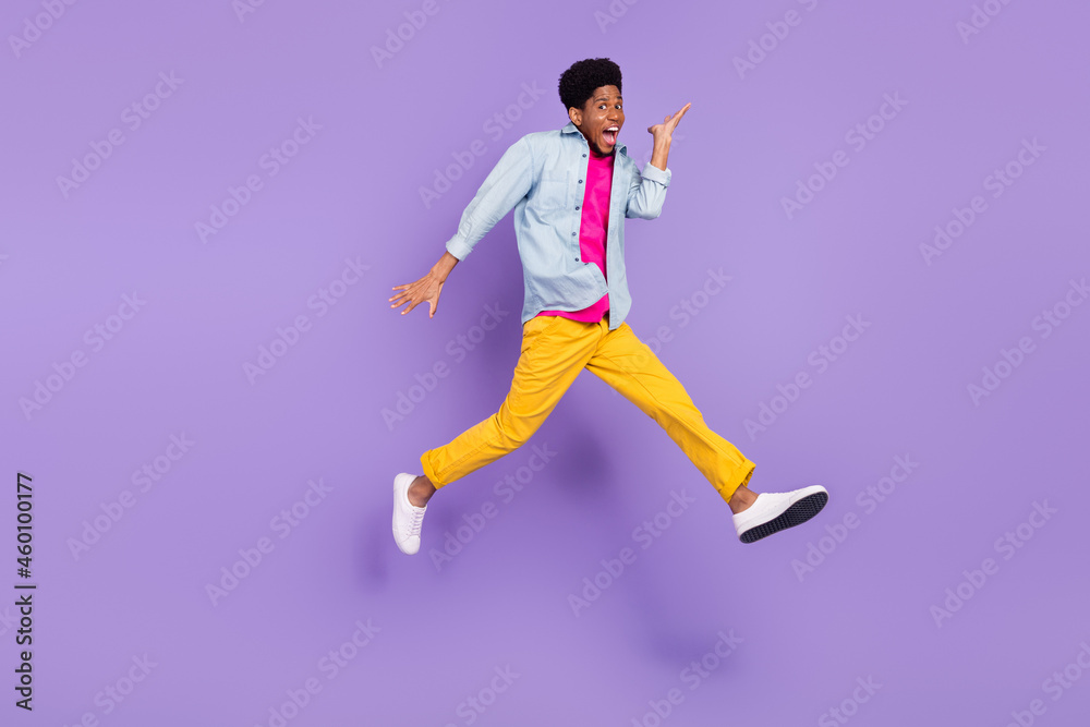 Photo of sporty runner guy jump move scream open mouth wear blue shirt pants isolated violet color background