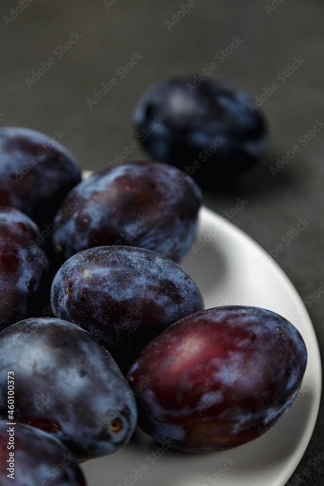 Fresh plums. Fruits. On a dark background. Copy space. Fresh plums. Fruits. On a dark background. Copy space.