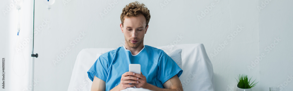 curly patient using smartphone while resting in hospital bed, banner