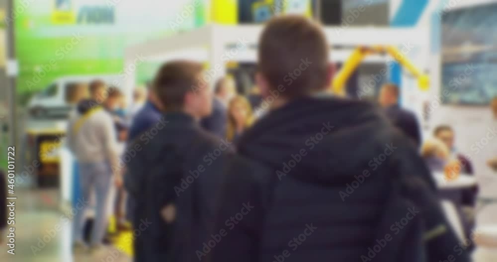 modern business life.defocused blurry video.background on a business theme with blurred silhouettes of unrecognizable people in a bright large hall.