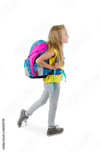 1-september concept. Back to school. Full length, legs, body, size vertical profile side view photo of small girl isolated on white background with backpack on shoulders
