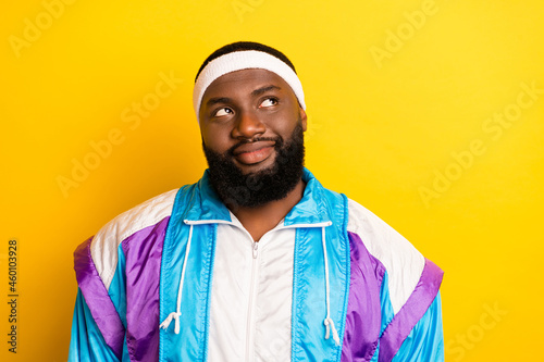 Photo of young afro man happy positive smile dream think look empty space isolated over yellow color background
