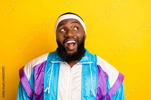 Photo of young afro man happy positive smile curious look empty space isolated over yellow color background
