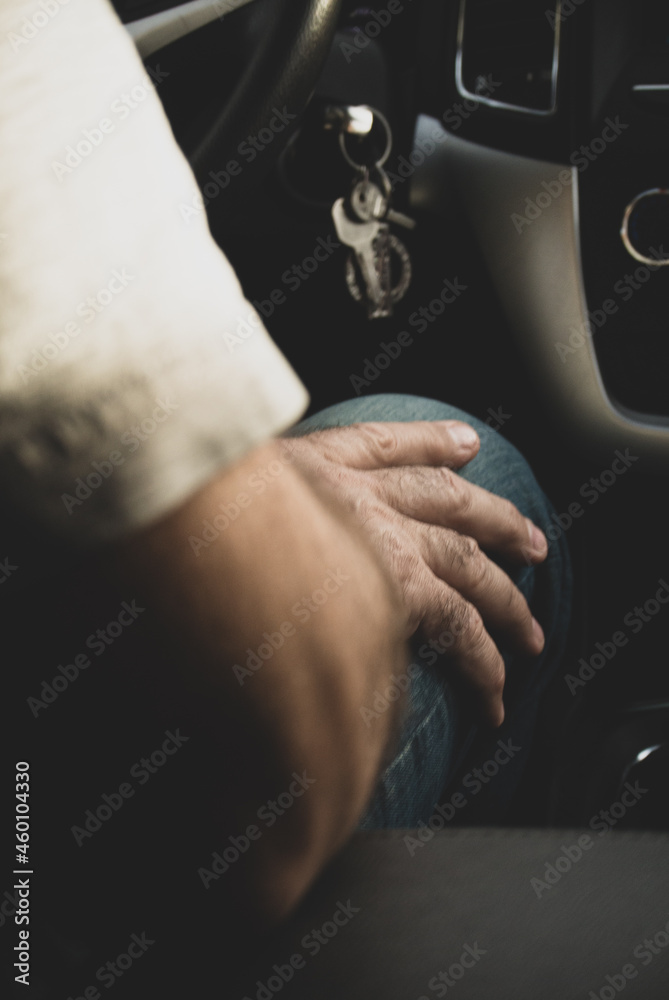 close up male hand in the car. safe trip concept