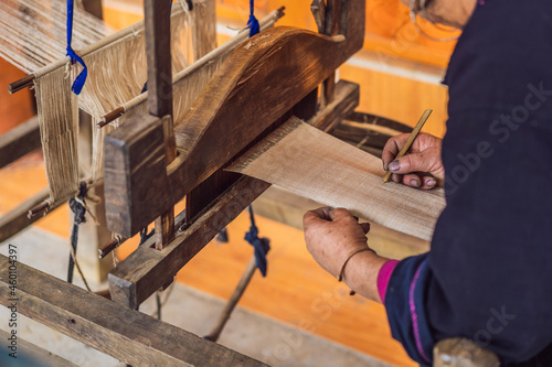 Fotografija Village women busy weaving silk saree on handloom