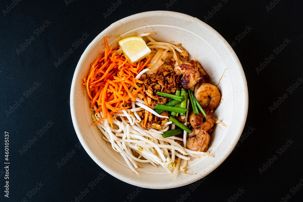 Asian dish Pad Thai prepared with noodles, grilled shrimps, soy sprouts, carrots pieces and sprinkle with peanuts to serve a delicious meal Asian dish Pad Thai prepared with noodles, grilled shrimps, soy sprouts, carrots pieces and sprinkle with peanuts to serve a delicious meal