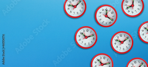 Alarm clocks with copy space on blue background