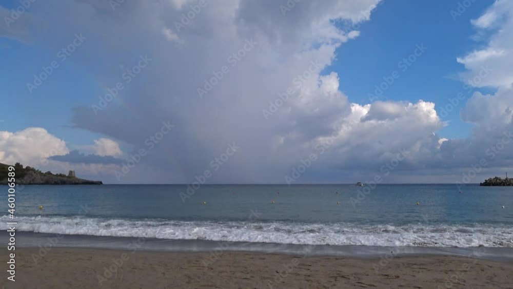 Imposing vertical nimbostratus fan-shaped making a rainbow at the horizon. 4K. Imposing vertical nimbostratus fan-shaped making a rainbow at the horizon. 4K.