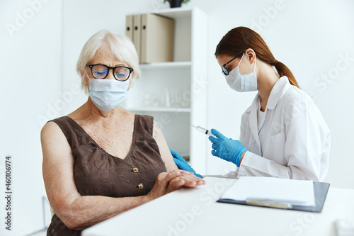 old woman wearing medical mask in the hospital for vaccinations covid-19 passport