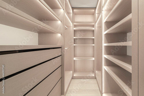 Wooden shelves with LED lighting inside closet cabinet, The vertical and horizontal strip LED light In wardrobe shelves. Modern minimalistic wardrobe interior photo