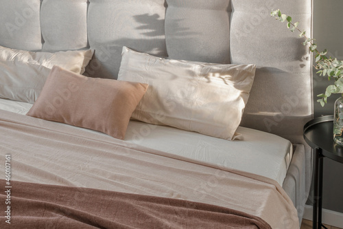 Linen pillow cushions in minimal bedroom interior. Beige, white and cream pillows